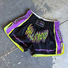 a pair of purple and black shorts laying on the ground