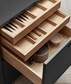 an open drawer with utensils in it