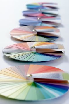 a row of color swatches sitting on top of a white table next to each other