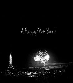 the eiffel tower is lit up at night with happy new year written on it