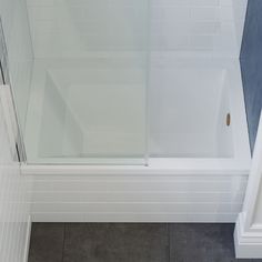 a bath tub sitting next to a walk in shower