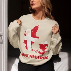 Show your love for Denmark with our Denmark Flag Sweatshirt, a cozy and stylish way to celebrate Danish culture. This Danish crewneck sweatshirt features the vibrant colors of the Danish flag design, making it a standout piece for fans of Copenhagen, Aarhus, and Odense travel. Ideal for Danish travel gifts, cute fall outfits, or as a cool addition to your European fashion wardrobe, this Denmark sweatshirt is perfect for everyone from Danish moms to Denmark soccer fans. Designed with comfort and Copenhagen T Shirt, Map Of Denmark, Denmark Map, Danish Flag, Danish Culture, Denmark Flag, Custom Crewneck Sweatshirts, World Map Decor, Denmark Travel