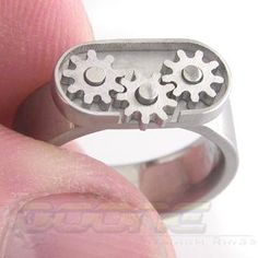 This is what's called a fidget ring. This ring has three interlocking spur gears that rotate when the center gear is rotated. The ring part was designed to be a normal feeling ring. You'll have a hard time not playing with it while it's on your finger. The ring shown is a size 8 and is 6mm wide. It will come in Brushed finish shown. Gear Ring, Cousin Gifts, Therapy Gift, Fidget Rings, Titanium Rings, Dream Ring, Hard Time, Wooden Crafts, Ring Size