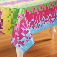 a colorful table cloth on top of a wooden table