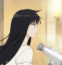 a woman with long black hair holding a blow dryer