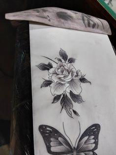 a piece of paper with a flower and butterfly on it