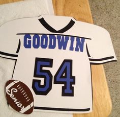 a football jersey cut out with the number 54 on it and a football in front