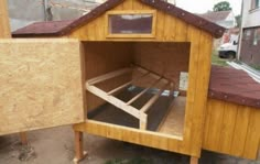 a chicken coop built into the side of a building