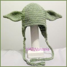 a crocheted baby yoda hat is on display