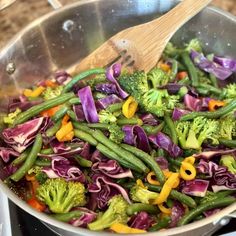 broccoli, red cabbage and green beans stir fry in a pan on the stove