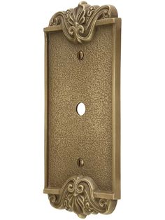 an antique brass finish light switch plate with ornate designs on the front and back sides