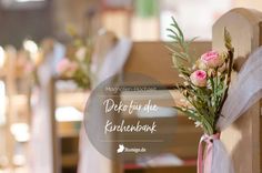 flowers are tied to the back of a wooden chair at a wedding ceremony in germany