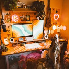 a computer desk topped with a desktop computer next to a lamp and other items in a room