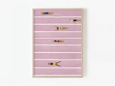 three people swimming in the water on pink and white striped wall art with wooden frame