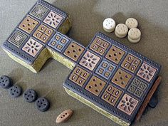 a close up of a game board on a table with buttons and other items around it