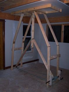 an unfinished room with wood framing on the ceiling