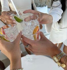 two women toasting with cocktails in their hands