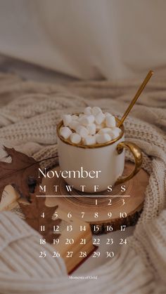 a cup filled with marshmallows sitting on top of a table