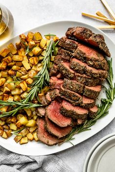 a white plate topped with steak and potatoes