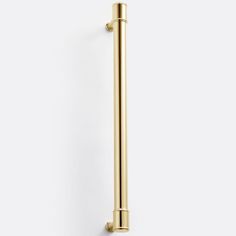 a gold door handle on a white wall