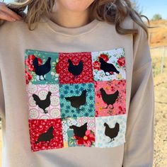 a woman wearing a sweater with chickens on it