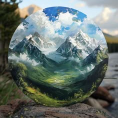 a painting on a rock with mountains in the background and water flowing through it,