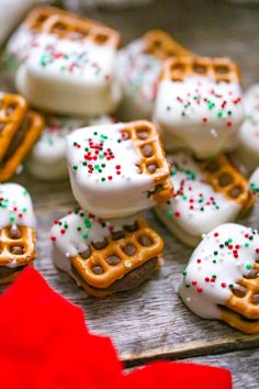 there are many small waffles with white frosting and sprinkles on them