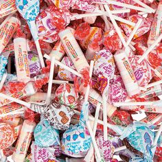 many candy lollipops are stacked on top of each other