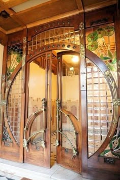 an ornate wooden door with glass panels