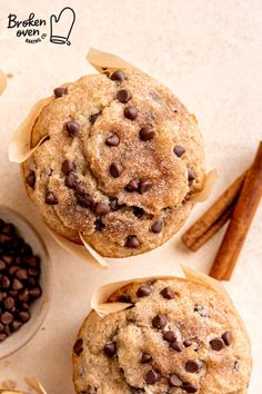 three chocolate chip muffins sitting on top of each other next to cinnamon sticks