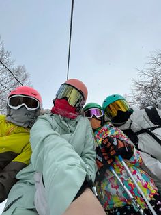 four skiers are taking a photo on the ski lift