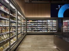 a grocery store filled with lots of food and drink bottles on display in glass cases