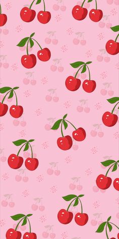 a pink background with cherries and leaves on it