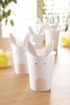 four paper cups with bunny ears on them