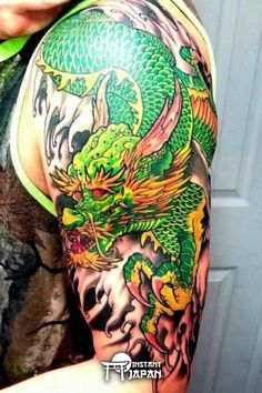 a man with a green dragon tattoo on his arm