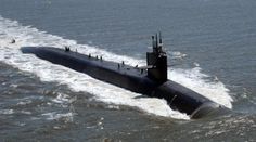 a submarine in the water with people standing on it