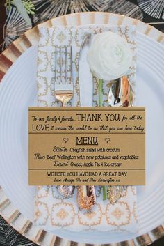 a white plate topped with a fork and knife next to a sign that says thank you