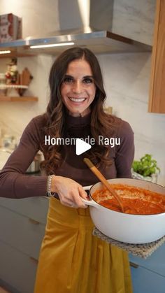 a woman holding a large bowl of food in her hands and smiling at the camera