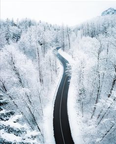 an aerial view of a winding road in the snow