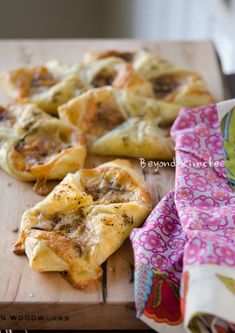 several different types of pastries on a cutting board