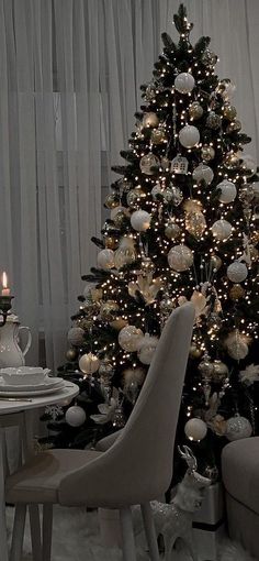 a decorated christmas tree with white and silver ornaments