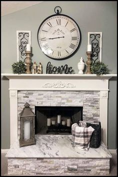 a fireplace with a clock above it and candles on the mantle next to an open fire place