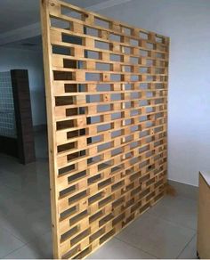 a room divider made out of wooden planks in an empty room with tile flooring