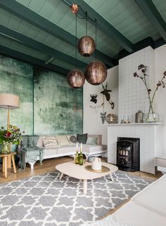 a living room filled with furniture and a fire place in front of a painting on the wall