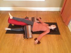 two women are doing yoga on the floor