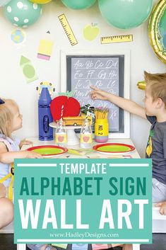 two children sitting at a table in front of a sign that says, template alphabet sign wall art