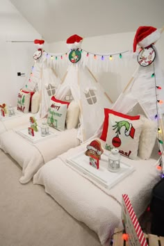 two beds with christmas decorations on them in a room