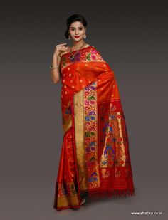 This Amoli Red Paithani Silk Saree with intrigue peacock design looks mesmerizing, giving a rich look right the moment you look at it. The luscious mono chrome paithani silk saree, with delicate muthuda work over brocaded pallu and border, marks itself as a creation of unique paithani silk drape. Traditional zari motif with an eye soothing red base is a must have. Sari Blouses, Katan Saree, Designer Sarees Online Shopping, Latest Indian Saree, Saree Style