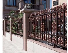 an iron fence on the side of a building