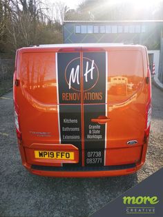 an orange van is parked in front of a building with the words m & f renovations on it